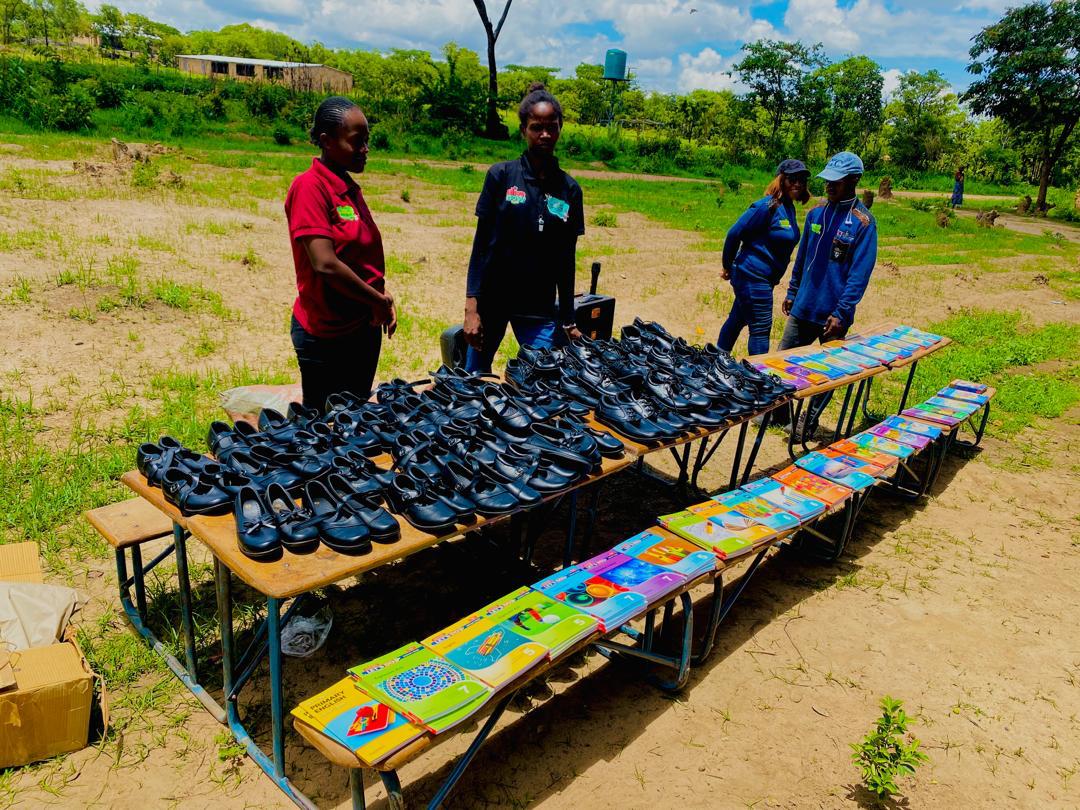 Tables laid out with school shoes and textbooks prepared for distribution by Lusean Child's Trust Foundation